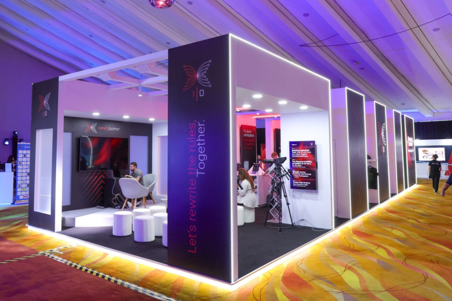 Bespoke exhibition stand with lighting and digital displays creating immersive brand experience by creative event agency