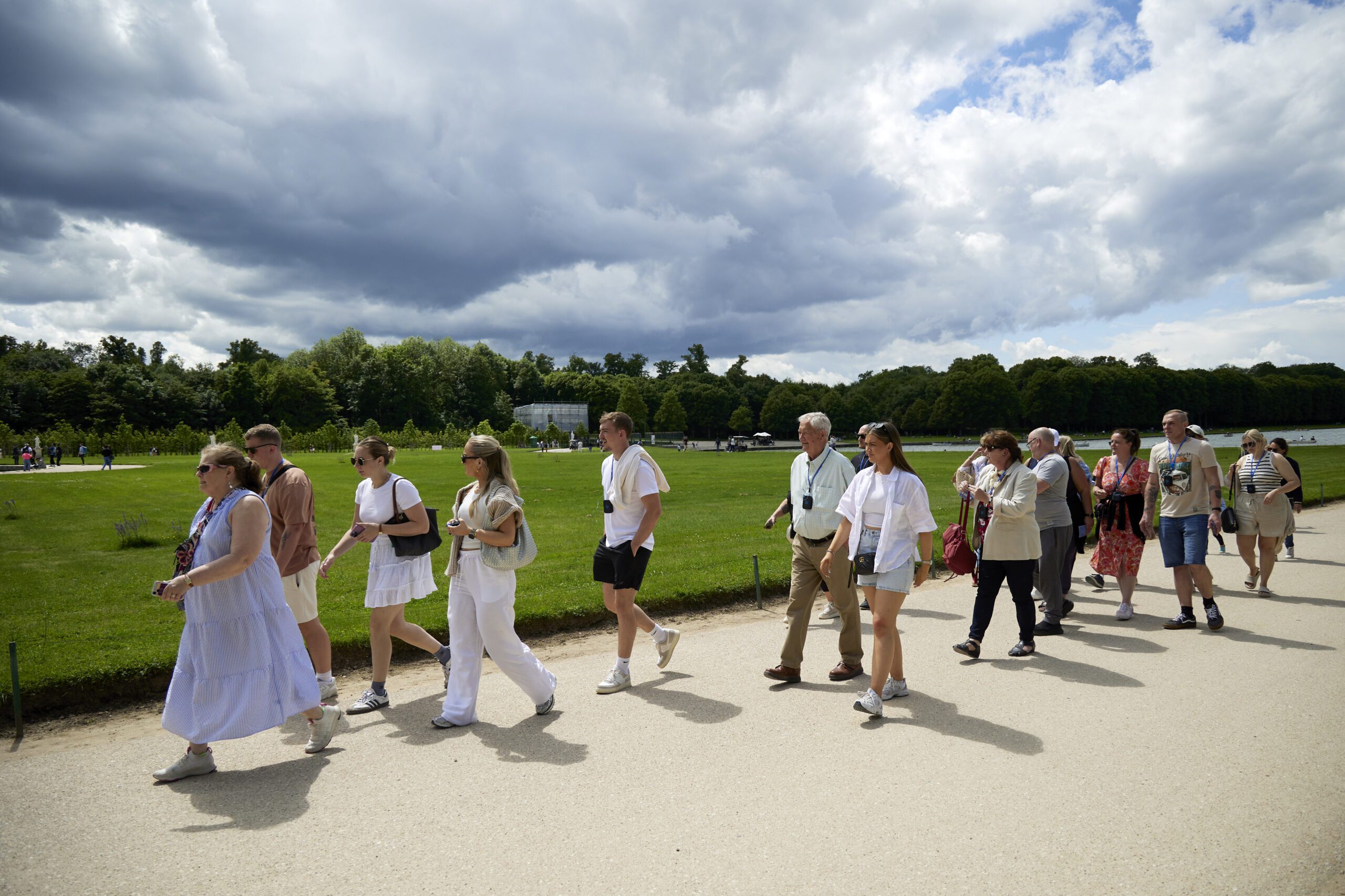 Corporate event attendees walking together during a communal wellness activity focused on connection and wellbeing.